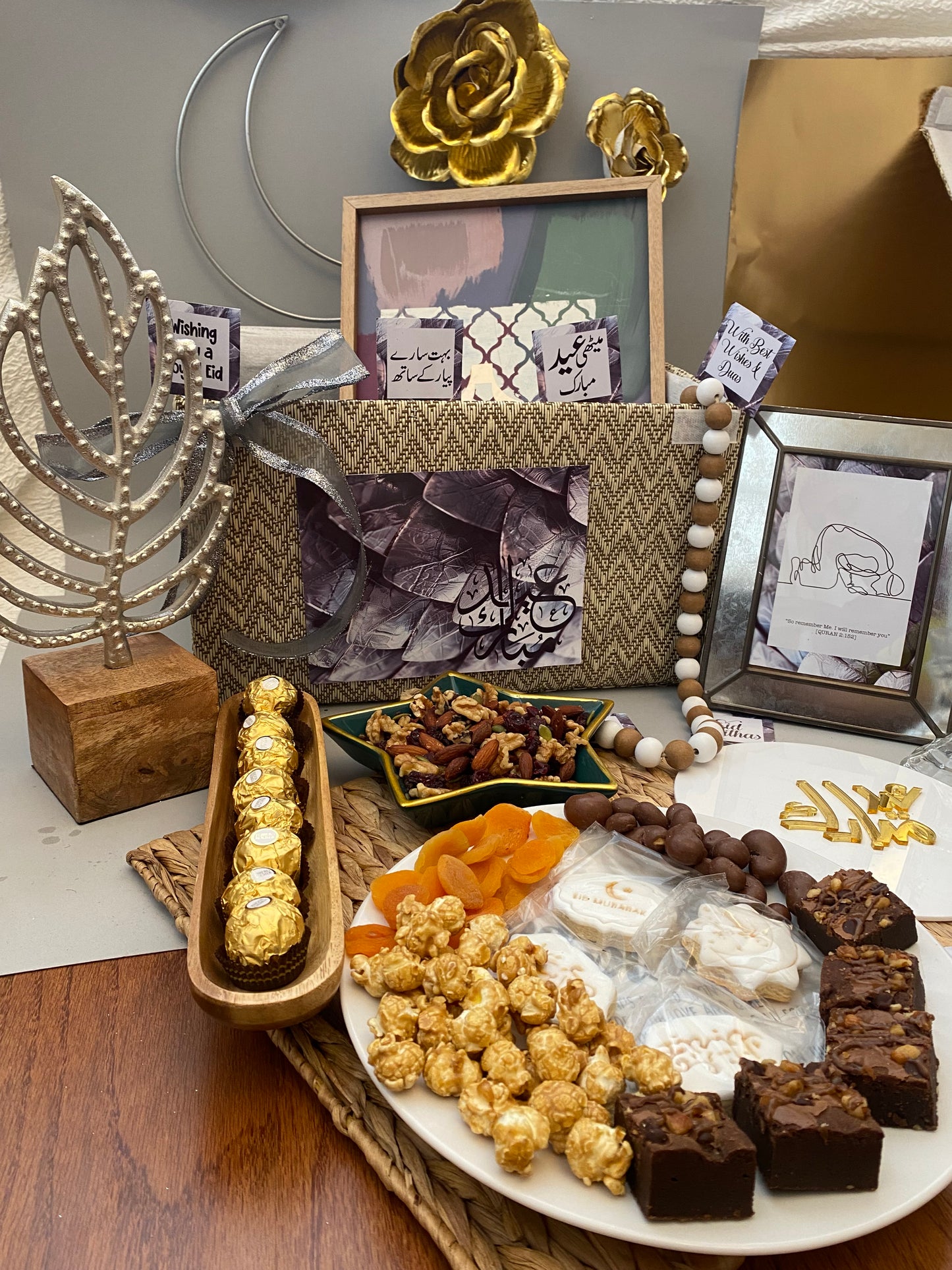 Decorative table setting with a plate of assorted snacks and decorative items.