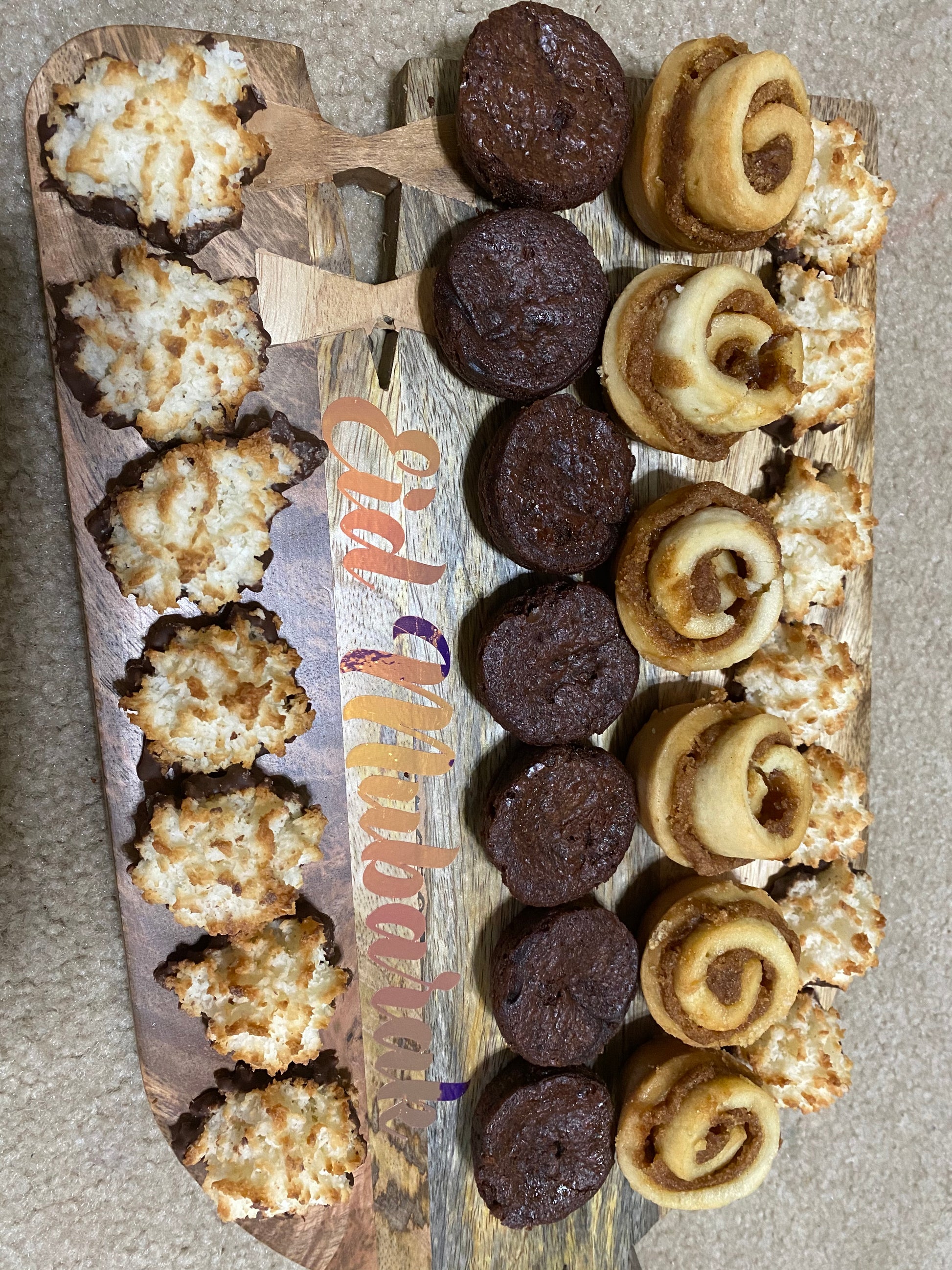 Assorted cookies on a wooden board with 'Eid Mubarak' text