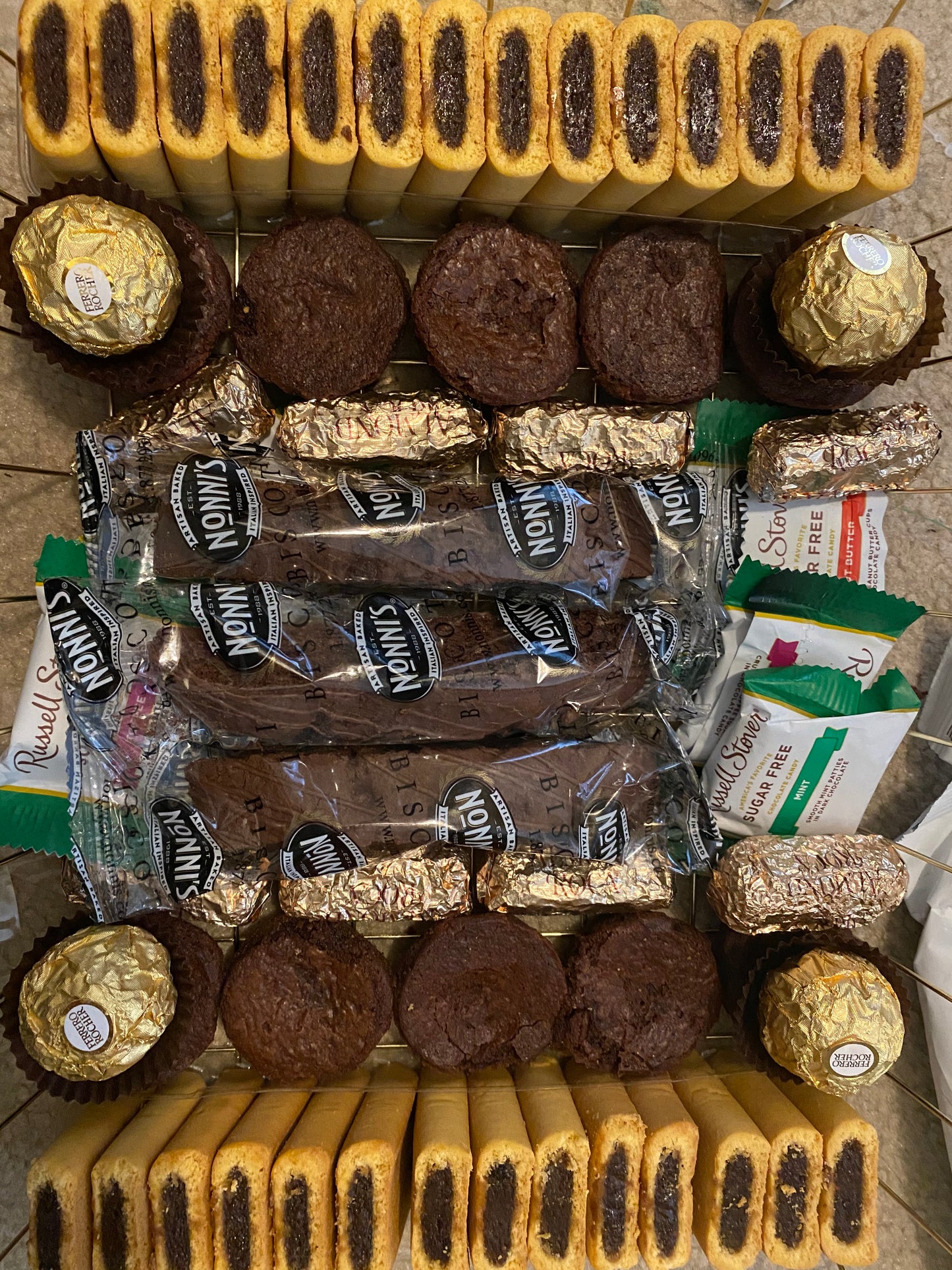 Assorted cookies and chocolates on a tiled surface