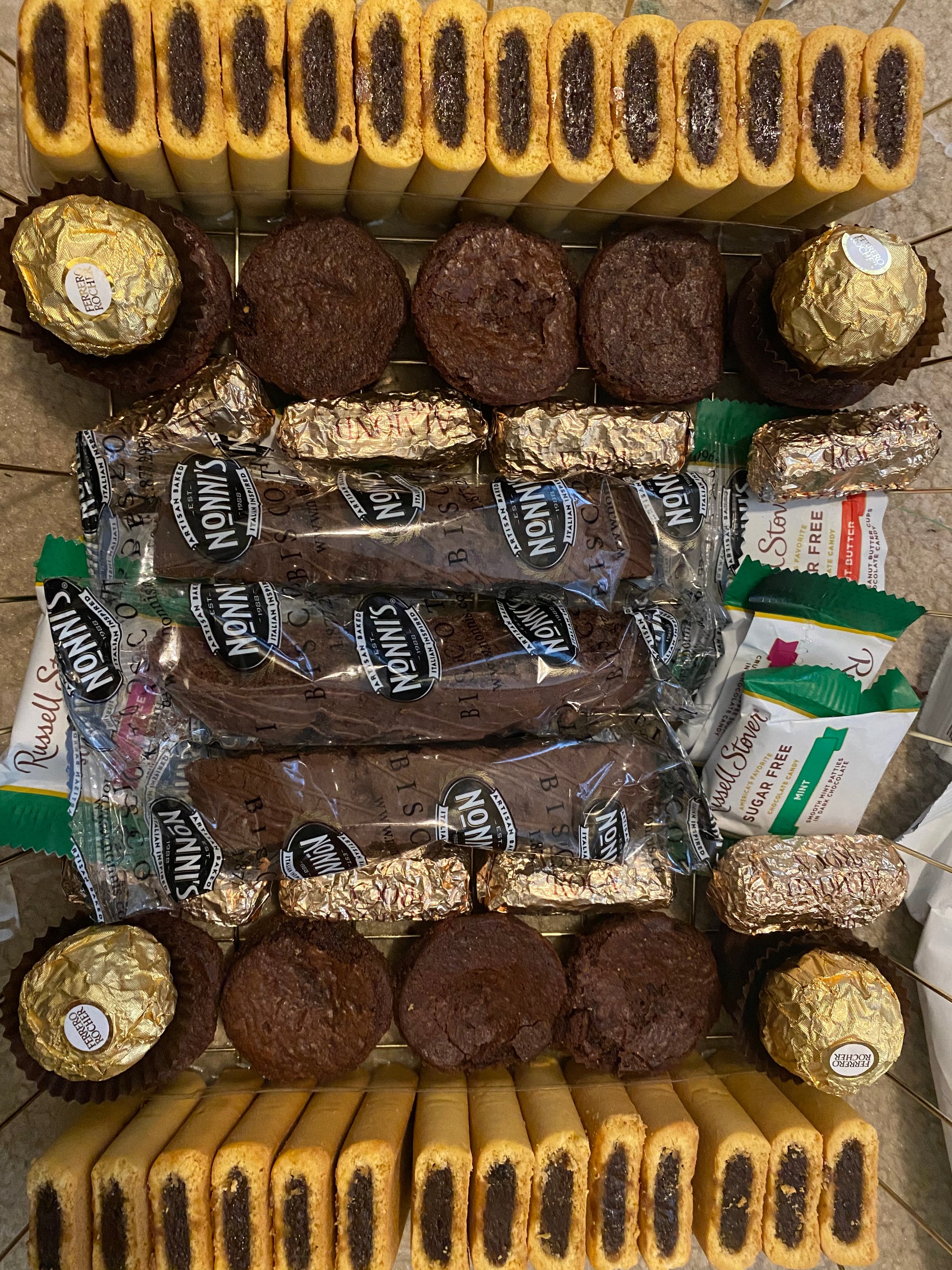 Assorted cookies and chocolates on a tiled surface